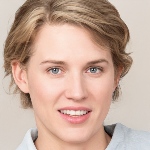 Joyful white young-adult female with medium  brown hair and blue eyes