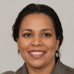 Joyful white adult female with medium  brown hair and brown eyes