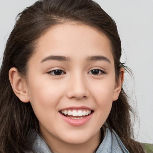 Joyful white child female with long  brown hair and brown eyes