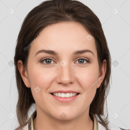 Joyful white young-adult female with medium  brown hair and grey eyes