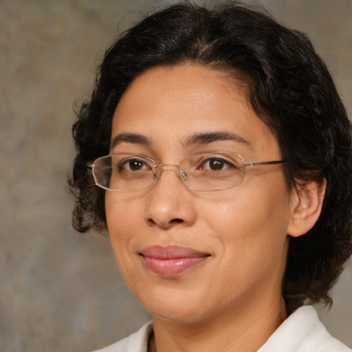 Joyful latino adult female with medium  brown hair and brown eyes