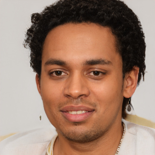 Joyful latino young-adult male with short  brown hair and brown eyes