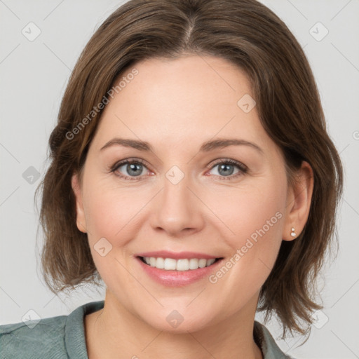 Joyful white young-adult female with medium  brown hair and green eyes