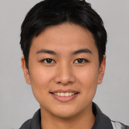 Joyful asian young-adult male with short  brown hair and brown eyes