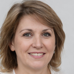 Joyful white adult female with medium  brown hair and grey eyes