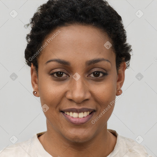 Joyful black young-adult female with short  black hair and brown eyes