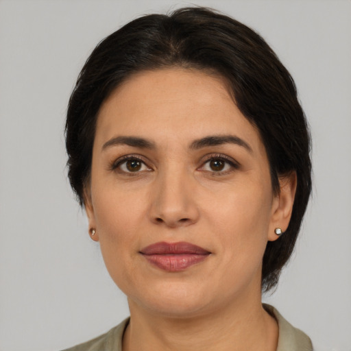 Joyful white adult female with medium  brown hair and brown eyes