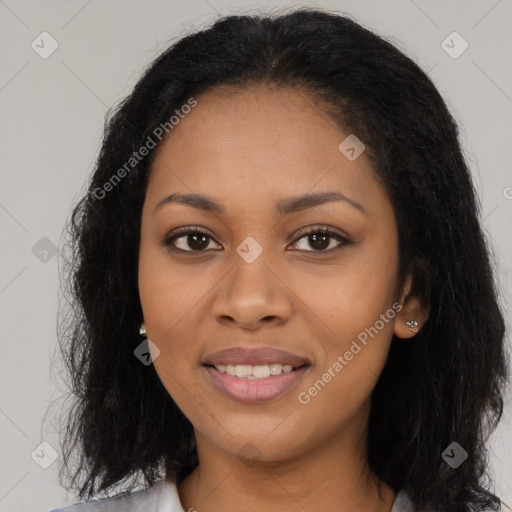 Joyful black young-adult female with long  black hair and brown eyes