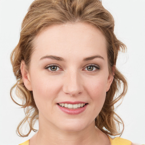 Joyful white young-adult female with medium  brown hair and blue eyes