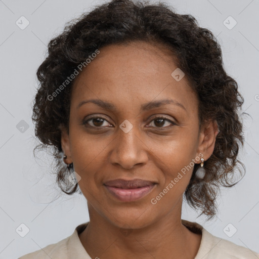 Joyful black adult female with medium  brown hair and brown eyes