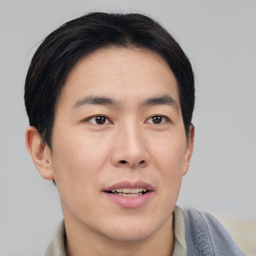 Joyful asian young-adult male with short  brown hair and brown eyes