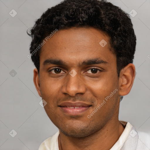 Joyful black young-adult male with short  brown hair and brown eyes