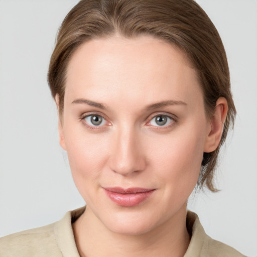 Joyful white young-adult female with medium  brown hair and blue eyes