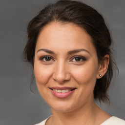 Joyful white young-adult female with medium  brown hair and brown eyes