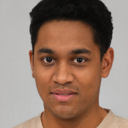 Joyful latino young-adult male with short  black hair and brown eyes