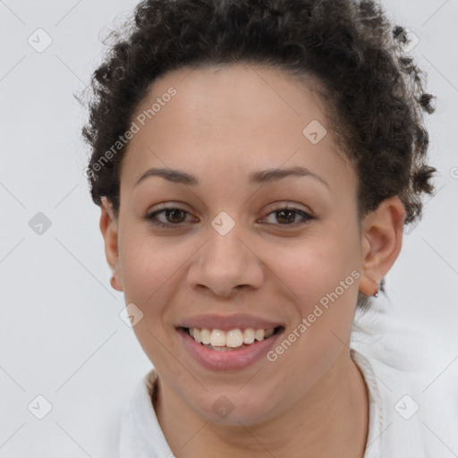 Joyful black young-adult female with short  brown hair and brown eyes