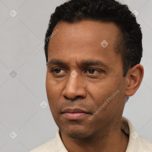 Neutral latino adult male with short  black hair and brown eyes