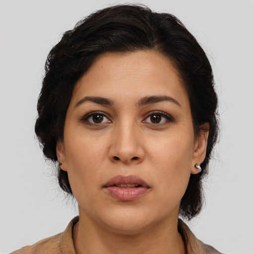 Joyful latino young-adult female with medium  brown hair and brown eyes