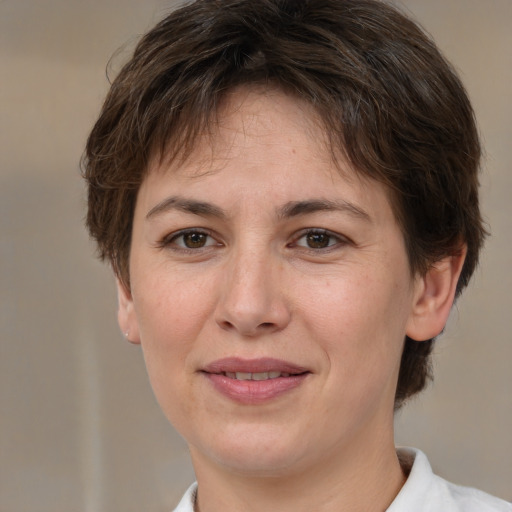 Joyful white adult female with medium  brown hair and brown eyes