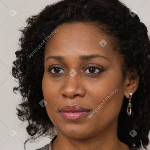 Joyful black young-adult female with medium  brown hair and brown eyes