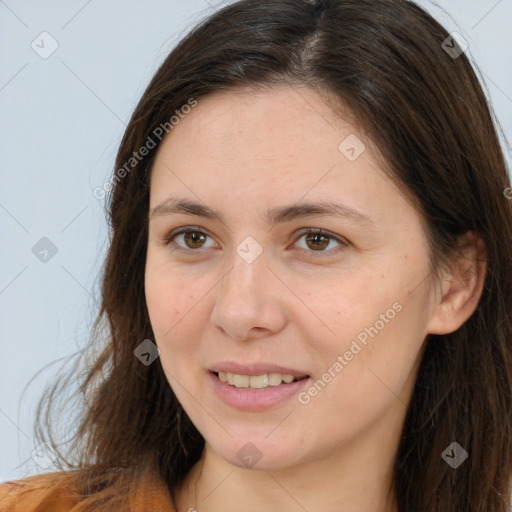 Joyful white young-adult female with long  brown hair and brown eyes