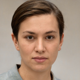 Joyful white young-adult female with short  brown hair and grey eyes