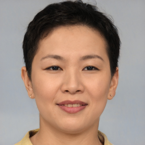 Joyful asian young-adult female with short  brown hair and brown eyes