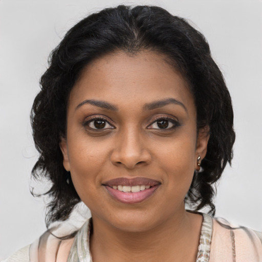 Joyful black young-adult female with medium  brown hair and brown eyes