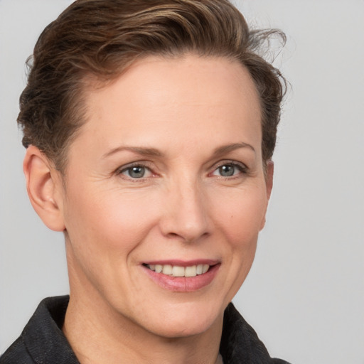 Joyful white adult female with short  brown hair and grey eyes