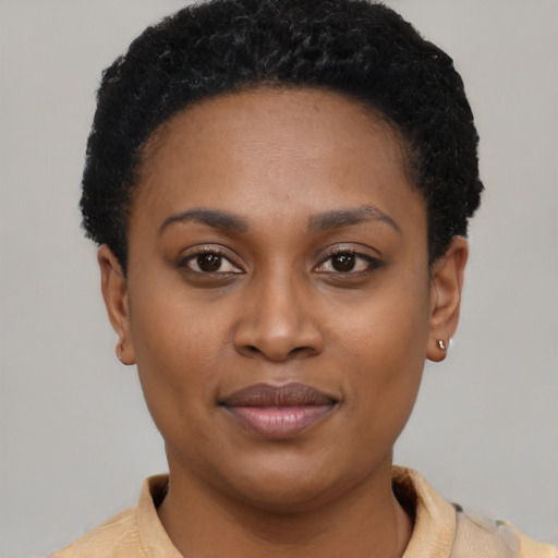 Joyful black young-adult female with short  brown hair and brown eyes