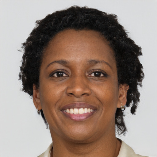 Joyful black adult female with short  brown hair and brown eyes