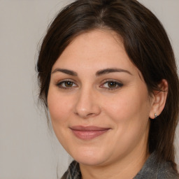 Joyful white adult female with medium  brown hair and brown eyes