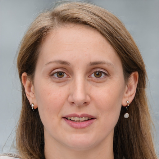 Joyful white adult female with long  brown hair and blue eyes