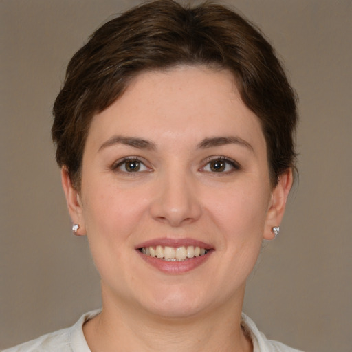 Joyful white young-adult female with short  brown hair and brown eyes