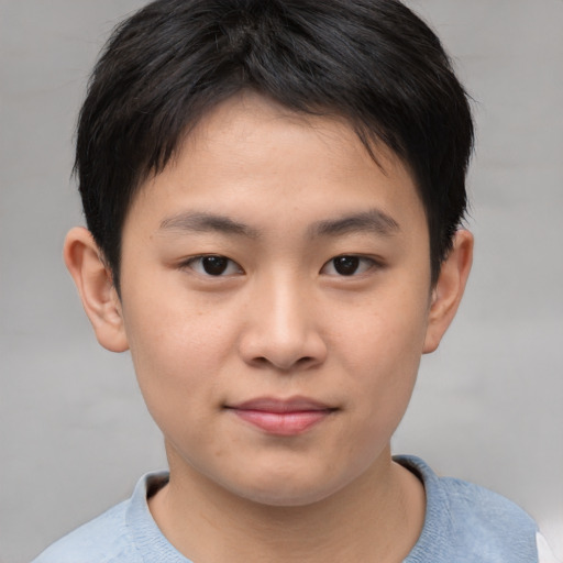 Joyful asian child male with short  brown hair and brown eyes
