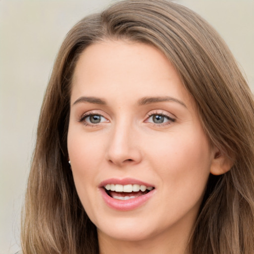 Joyful white young-adult female with long  brown hair and green eyes