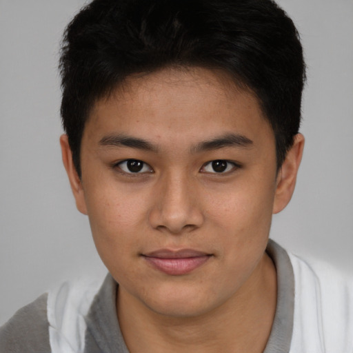 Joyful asian young-adult male with short  brown hair and brown eyes