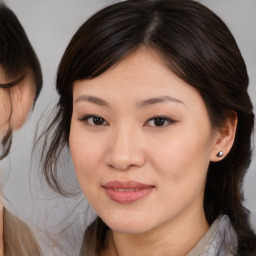 Joyful asian young-adult female with medium  brown hair and brown eyes