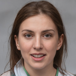 Joyful white young-adult female with medium  brown hair and grey eyes