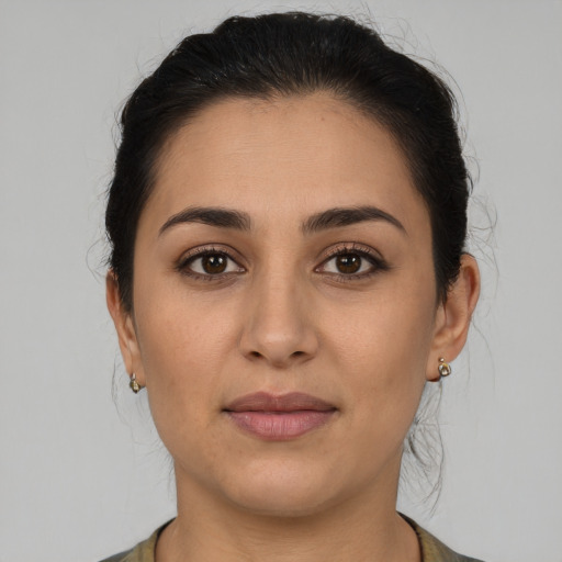 Joyful white young-adult female with medium  brown hair and brown eyes