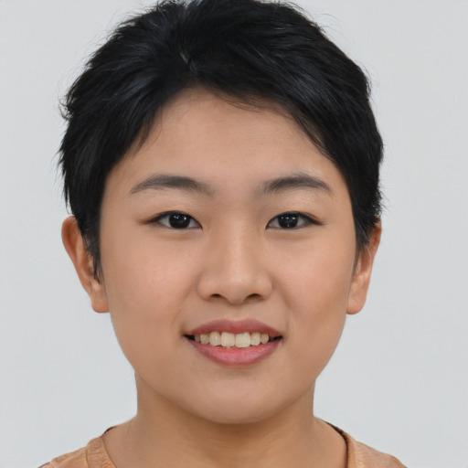 Joyful asian young-adult female with short  black hair and brown eyes