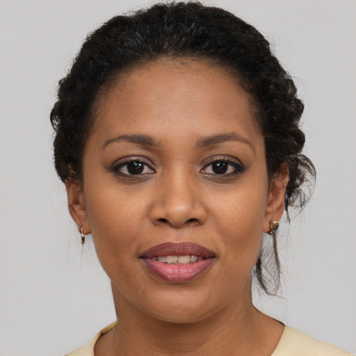 Joyful black young-adult female with short  brown hair and brown eyes