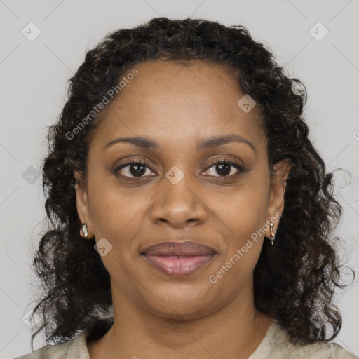 Joyful black young-adult female with long  brown hair and brown eyes