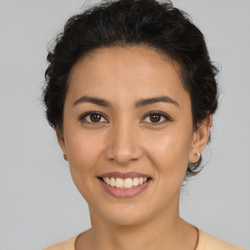 Joyful latino young-adult female with medium  brown hair and brown eyes