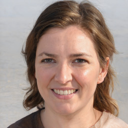 Joyful white young-adult female with medium  brown hair and blue eyes