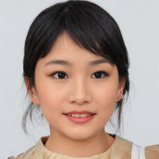 Joyful asian young-adult female with medium  black hair and brown eyes