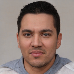 Joyful white young-adult male with short  black hair and brown eyes