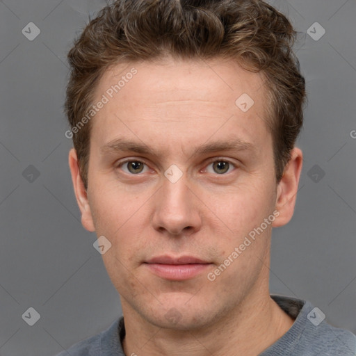 Joyful white adult male with short  brown hair and grey eyes