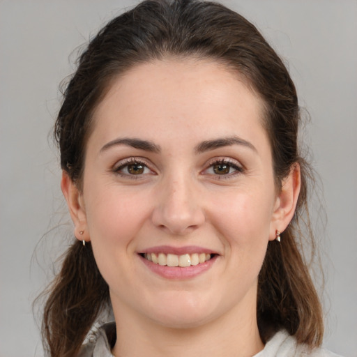 Joyful white young-adult female with medium  brown hair and brown eyes