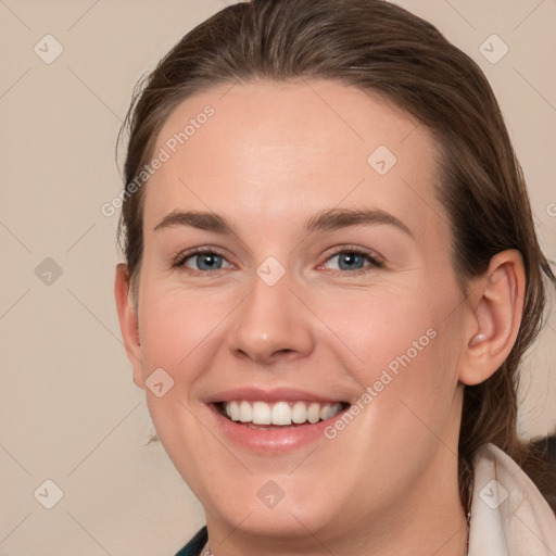 Joyful white young-adult female with long  brown hair and blue eyes